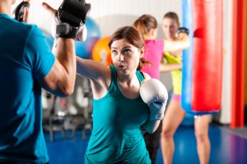Female kravist with trainer in sparring